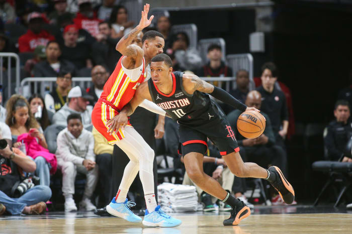 Hawks guard Dejounte Murray (5) defends Houston Rockets forward Jabari Smith Jr. (10) in the first quarter at State Farm Arena.
